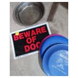 Dog Bowl, Plastic Discs, and Warning Sign