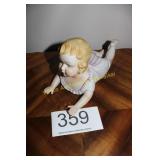 Large Bisque Reclining Piano Baby