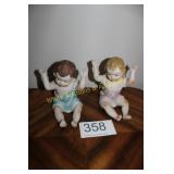 Large Pair of Seated Bisque Piano Babies