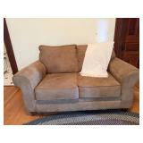Over stuffed love seat with afghan