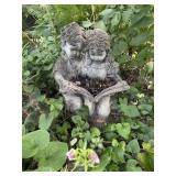 Cement statue boy & girl reading book 15'W x 12'D.