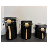 Set of 3 black canisters with wooden spoons