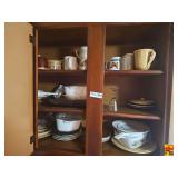 Selection of various kitchen items including mugs, plates, bowls, glassware, and assorted serving dishes. Some items are stackable.