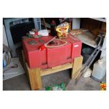Red Polyethylene Utility Tank with Siphon Pump on Wooden Stand