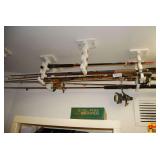 Collection of Fishing Rods and Reels with Wall-Mounted Rack