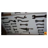 Collection of Cast Iron and Steel Wrenches Displayed on Pegboard