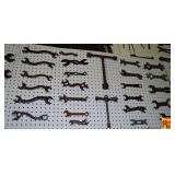 Assorted Collectible Metal Wrenches and Hand Tools on Pegboard Display
