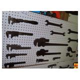 Assorted Metal Hand Wrenches and Pipe Wrenches Wall Display