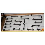 Collection of Cast Iron Farm and Implement Wrenches on Pegboard Display