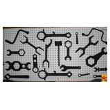 Collection of Assorted Metal Sprinkler and Utility Wrenches on Pegboard