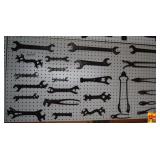Assorted Metal Wrenches and Tools Mounted on Pegboard