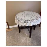 Round Wooden Table with Glass Top and Lace Tablecloth