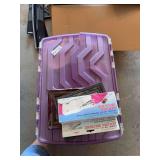 Storage Tote Containing Yellow Bowls, White Dinnerware, Handheld Sewing Machine, and Picture Frame