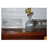 Lot of 2 Glass Insulators, Cut Glass Decanter with Butterfly Stopper, and University Football Championship Metal Novelty Plates