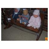 Three Porcelain Baby Dolls in Wooden Rocking Cradle with Painted Heart Cutouts