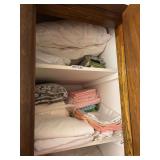 Assorted Linens, Blankets, Bath Towels, and Paper Goods Stored in Cabinet