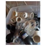Assorted PVC Pipe Fittings and PlumbOwik Couplings in Storage Bin