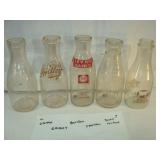Five Quart Sized Milk Bottles