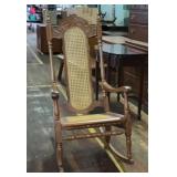 Handcrafted rocking chair with cane back and seat