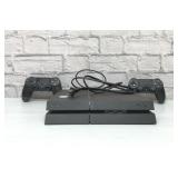Sony PlayStation 4 with controllers and power cord