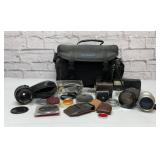 Camera bag with assorted accessories, lenses