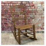 Antique rocking chair with woven seat