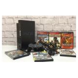 PlayStation two with controller and games