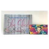 Two metal signs, " SHE SHED", "BETTY BOOP"