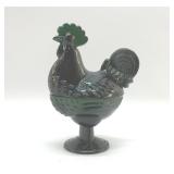 EMERALD GREEN ROOSTER ON A NEST