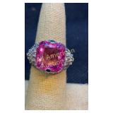 Cushion-cut pink gemstone with white accent stones