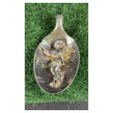 Flute playing angel in a spoon pendant, unknown