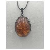 Large Carved Amber Looking Pendant