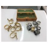 Case With Brass And Monogrammed Napkin Rimgs