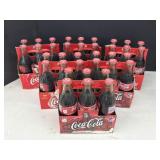 Assorted Coke Bottles In Cardboard Carriers