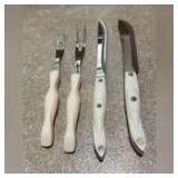 2 Cutco knives and 2 meat forks with heifer handles