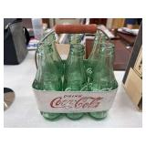 Vintage Coca-Cola bottles in metal caddy