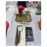 Magnifying glass, letter opener, tweezer set, tin, kitchen shears, bottles, vase, tray