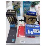 Olympus camera, photo paper, VHS tapes, water broom, baseboard buddy,
