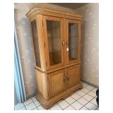 Large lighted cabinet with glass doors and shelves