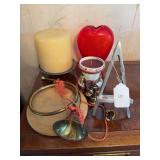 Decorative brass horn, brass bells, candles, red glass vase