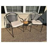 Pair of metal patio chairs with cushions, small table and decorative lantern