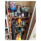 Shelf with contents: lawn care products, flags, soils, landscaping weed barrier, oil, paint