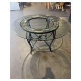 48” round glass top table with iron base and granite stone inlay. 29” high. Retail price $849