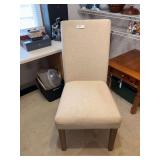 Tan colored chair with areas of soil noted