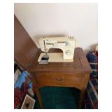 Golden sewing machine in cabinet, buttons, cutting mat