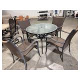 Glass top wrought iron patio table and 4 metal framed chairs