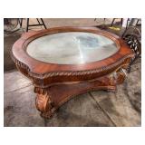 Glass top heavily carved coffee table
