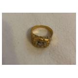 14kt man’s ring with diamond that shows what appears to be carbon specks with  loop. Has not been cleaned .