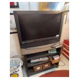 37' Olevia television with remote, TV stand, DVD/VHS player, CD's