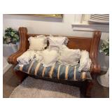 Antique oak church pew with white lace pillows